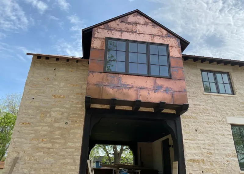 Copper metal panel facade on a stone building for Skylight Installation in San Diego Country Estates